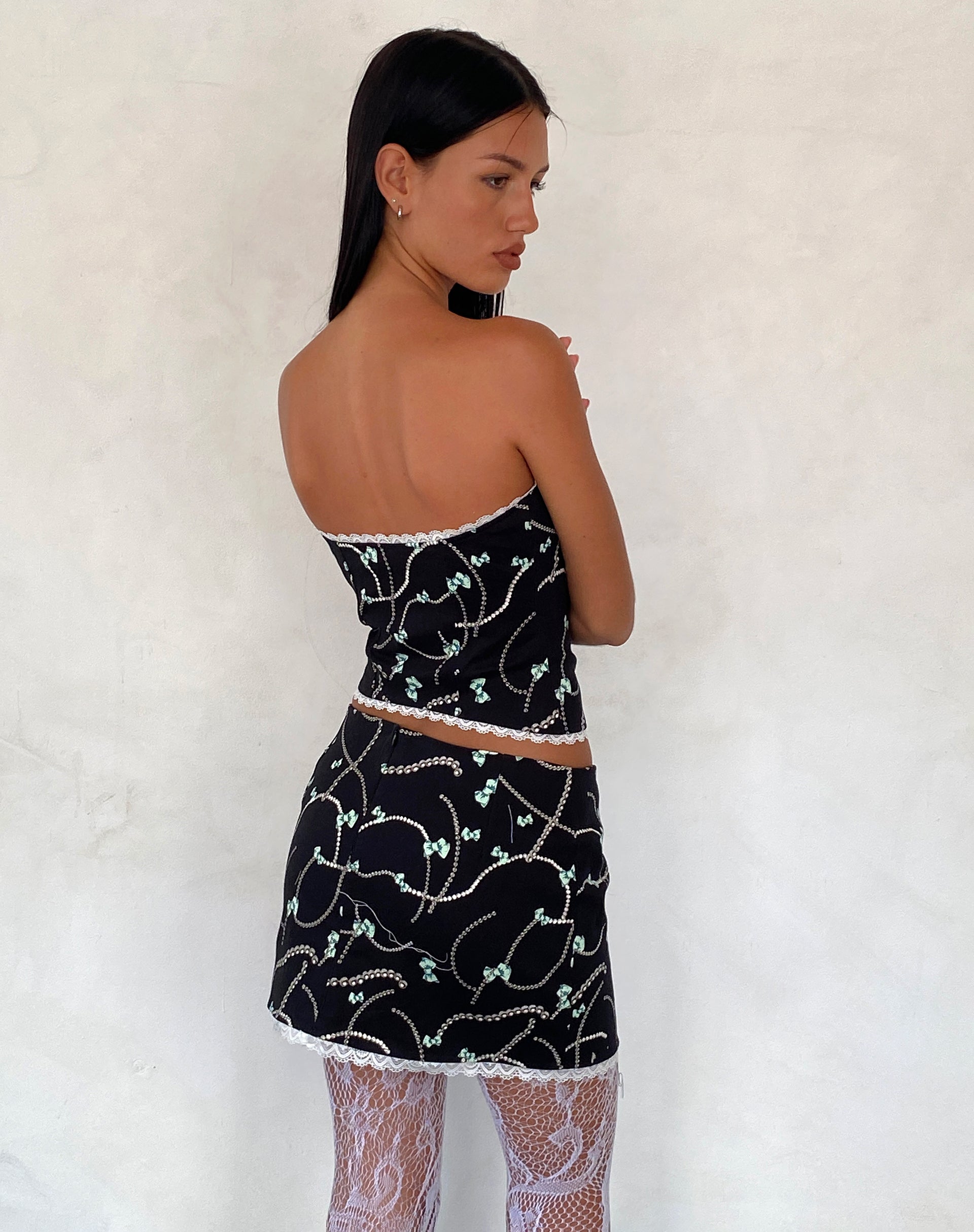 Image of Molen Mini Skirt in Black with Pearl and Bow Print